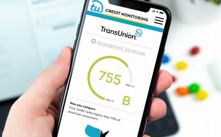 Smartphone showing a credit score of 755 with TransUnion